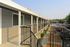 The outside of a building is depicted, featuring a large parking lot that provides ample space for vehicles.