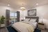 Modern bedroom staging with queen bed