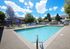 Sparkling pool with blue sky and lounge furniture
