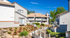 blue skies over the community that has a arizona style landscaping with a pathway that flows through the community