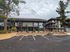 Two story apartment building with surface parking in front