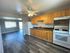 Lsrge kitchen with black granite countertops and hardwood floors
