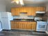 Lsrge kitchen with black granite countertops and hardwood floors