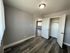 Bedroom with walk-in closet and hardwood floors