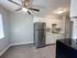 white cabinets with silver nickel finishes. stainless steel sink and quartz countertops