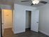 Interior view of a room with a ceiling fan and two doors, highlighting a spacious and airy atmosphere.