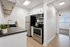 white kitchen with dark countertops and stainless steel appliances