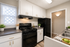 A spacious kitchen displaying a stove, refrigerator, and sink, designed for efficiency and everyday use.