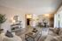 An empty room featuring sliding glass doors and polished hardwood floors, creating a bright and spacious atmosphere.
