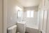 Newly remodeled bathroom with white fixtures and large window