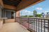 Charming balcony view with glimpses of the community parking and lush greenery, perfect for relaxation.