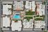 Luxurious aerial view of a modern apartment complex featuring a sparkling blue swimming pool, lush green landscaping, and sleek architectural design, offering a serene and inviting living environment.