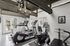 Modern apartment gym with natural light, featuring state-of-the-art treadmills, exercise bikes, and inspiring wall art.