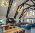 Spacious communal lounge with vaulted ceilings, stylish lighting fixtures, and modern seating arrangements.