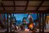 Idyllic outdoor space with cozy fire pit, surrounded by modern wooden houses under twilight skies.
