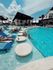 Inviting outdoor pool area with lounge chairs and stepping stones on a sunny day.