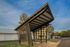 Innovative pavilion with modern architectural design featuring angled beams and a sleek roof.