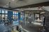 State-of-the-art fitness center with modern equipment, vibrant blue accents, and natural light.