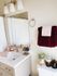 Chic bathroom featuring a modern vanity, stylish fixtures, and plush burgundy towels.