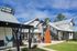 Contemporary apartment complex with a stylish courtyard featuring landscaped gardens and artistic sculptures.