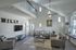 Bright and airy living room with stylish gray sofas, modern decor, and a wall-mounted TV.
