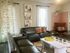 Contemporary living room with stylish leather sofas, modern art, and cozy accents.