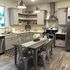 Contemporary kitchen with sleek gray cabinetry, stainless steel appliances, and a stylish dining area.