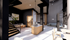 Modern open-concept loft with a sophisticated lounge area, stylish wooden accents, and ample natural light.