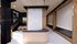 Modern apartment interior showcasing a chic staircase, elegant wooden finishes, and stylish seating area with abundant natural light.