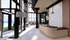 Modern and spacious apartment lobby with high ceilings, large windows, and elegant furnishings, offering a welcoming ambiance.