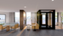 Modern living area with elegant furniture, large windows, and a stunning outdoor view, creating a bright and welcoming atmosphere.