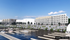 Modern waterfront apartment complex with sleek architecture and a scenic boat dock, offering a perfect blend of luxury and tranquility.