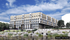 Modern riverside apartment complex with elegant architecture, lush landscaping, and scenic views.