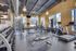 Bright and modern apartment gym featuring state-of-the-art equipment, abundant natural light, and a welcoming atmosphere.
