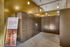 Modern parcel delivery room with secure lockers and sleek metallic design, offering 24/7 access to simplify package collection.