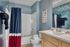 Chic bathroom featuring vibrant blue accents, modern fixtures, and stylish vanity in a welcoming home.