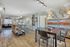 Charming open-plan living area with a modern kitchen, dining space, and cozy seating, featuring stylish decor and abundant natural light.