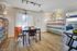 Charming apartment with a cozy reading nook, featuring modern wooden flooring, stylish bookshelves, and elegant decor.