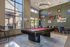 Chic recreation room with a stylish pool table, modern seating, and large windows offering natural light.