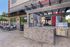 Chic outdoor patio with stylish brick barbecue area, modern seating, and scenic views.