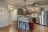 Contemporary kitchen with stainless steel appliances, elegant pendant lighting, and a chic breakfast bar with stylish stools.
