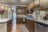 Modern kitchen with elegant wooden cabinetry, stainless steel appliances, and sleek countertops, offering a welcoming and functional space.