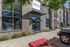 Inviting apartment entrance with modern brick facade, large windows, and vibrant red accents at Champions Club.