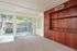 Photo of carpeted living room, screened porch, and oak-styled wall