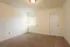 Photo showing carpeted bedroom with 1 window, 2 power outlets and a cable connection.