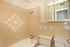 Photo showing bathroom with tub, toilet, sink, tiled walls, and medicine cabinet.,