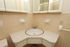 Photo showing bathroom vanity with sink, 2 soap holders, a towel bar and 2 separate medicine cabinets.