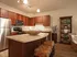 Kitchen with granite counters, stainless steel appliances, and brown cabinets.