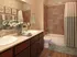 Bathroom showing step in tub, toilet, and counter.