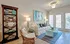Living room with furniture and wood panel flooring.
